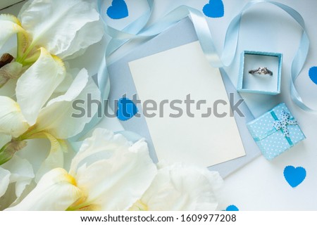 card mockup with iris and envelope. wedding invitation in minimalist style with blue hearts and ring box. valentine's day