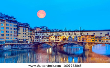 Bridge of Ponte Vecchio on the river Arno with full moon - Florence, Italy "Elements of this image furnished by NASA "
