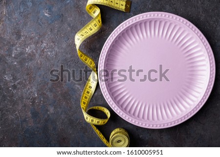 Empty plate and measure tape. Diet food concept.  Copy spce. Top view