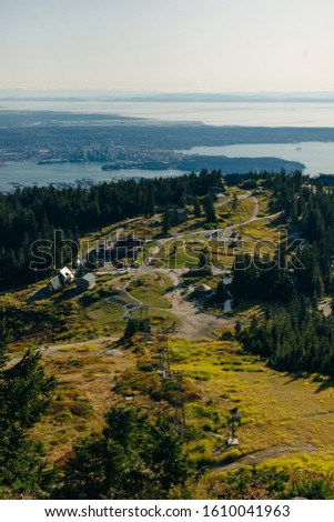 Aerial View of Grouse Mountain with Downtown city. North Vancouver, BC, Canada.