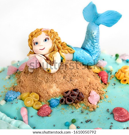 Mermaid cake against the background of shells and sand