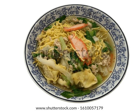 Red pork noodles in a bowl with vegetables and white background Is a food menu. - stock photo
