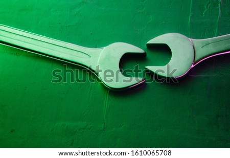 Two wrenches on a textured background.