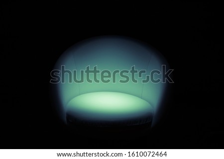 an empty chair in the studio with a black background 