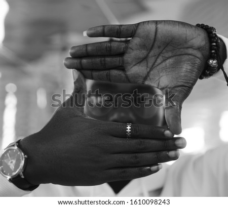 african american man making frame hand. African male making frame sign with his hands on white background. 