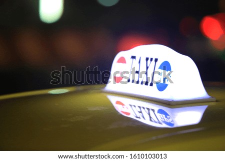 taxi lightbox in street at night