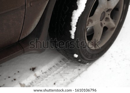 wheel of a crossover, SUV, on white snow, close-up