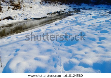 Winter landscape with the river and snow in frosty day