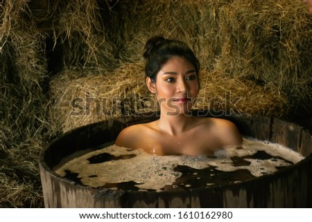 portrait of Asian woman take a shower outdoor at countryside.