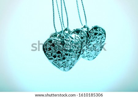 Heart on chain. Three blue hearts. Valentine's Day holiday. Blue hearts for boys and men.