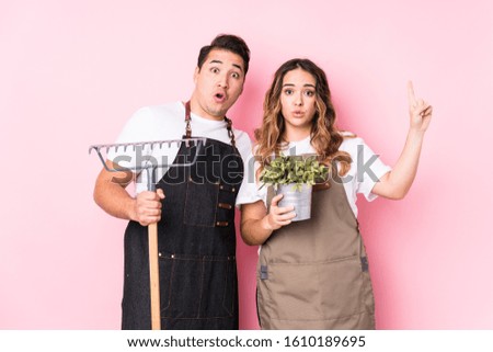 Young couple gardener isolated having some great idea, concept of creativity.