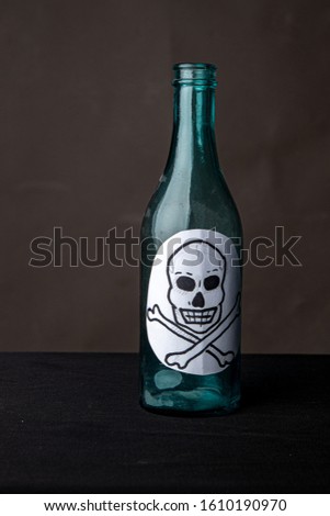 Bottle of alcohol poison with skull