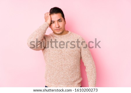 Young curvy man posing in a pink background isolated tired and very sleepy keeping hand on head.