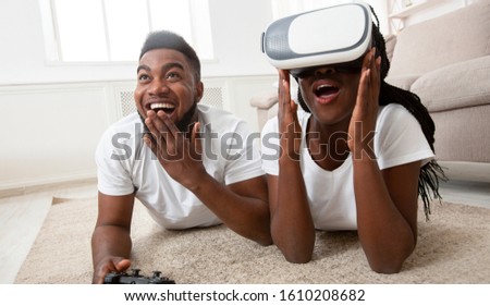 Virtual Reality. Excited Black Couple Trying VR Glasses While Playing Video Games At Home, Panorama