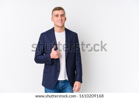 Young business caucasian man smiling and raising thumb up