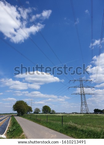 Scenery of rural sites while walking and making pictures of cloud, sky, grass, agricultural fields and electrical poles outdoors. 