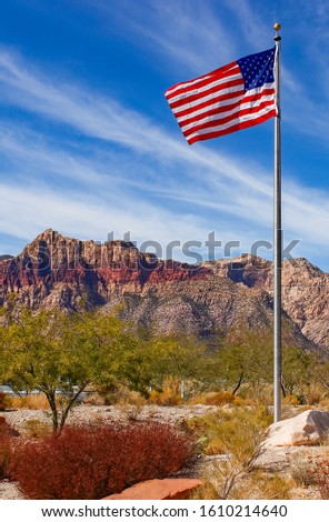 USA flag waving in front of the Red Rock Canyon Visitor Center, Nevada, USA
