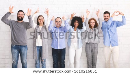 Happy friendship. Cheerful funny millennials posing with different gestures at studio