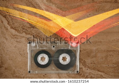 Vintage music cassette tape on texture background.