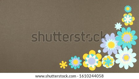 Image frame background of blooming paper flowers on a colored background.