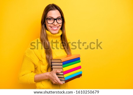 Turned photo of cool confident library worker copyspace want start success fall studying day hold pile stack books wear knitted collar jumper isolated bright yellow color background
