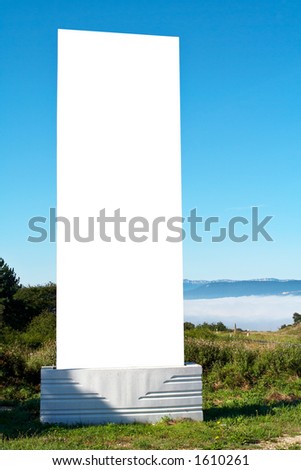 Blank billboard on blue sky in a mountainous area, just add your text