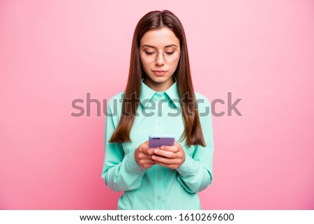 Photo of pretty lady holding telephone hands reading new post text before share with followers wear specs teal shirt isolated pink color background