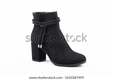 Womens fashion boots shot in studio on a white background.