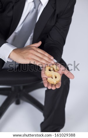 Businessman is petting Dollar icon in his hand