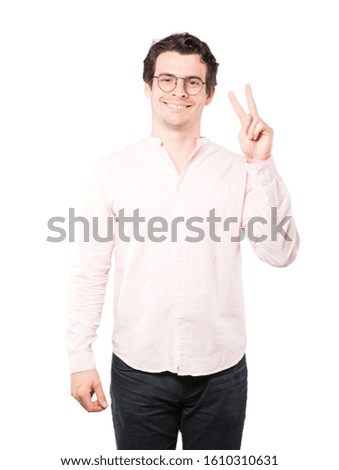 Happy young man making a victory gesture with his fingers