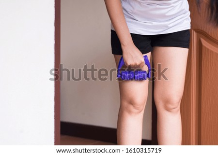 Woman using plastic roller with legs to remove pain,Massage muscles