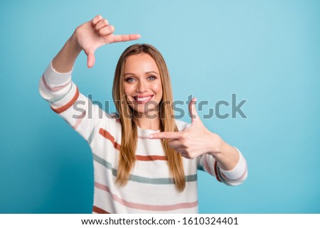 Photo of cheerful positive cute pretty nice woman smiling toothily pretending to take shot isolated over pastel color background