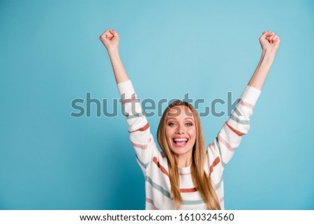 Photo of cheerful positive rejoicing woman raising her hands smiling toothily screaming with victory isolated pastel color background