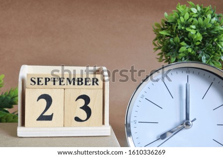 September 23, Cover design with silver - white clock in natural concept.