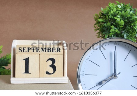 September 13, Cover design with silver - white clock in natural concept.