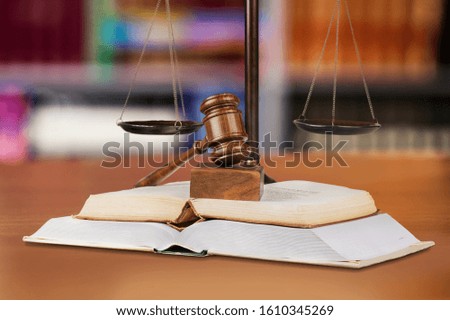Justice Scales and books and wooden gavel on table