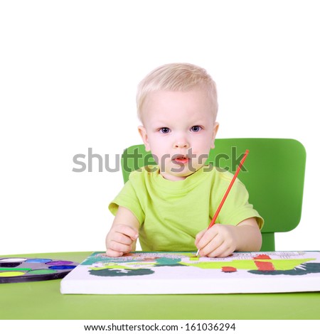 cute little talented boy painting