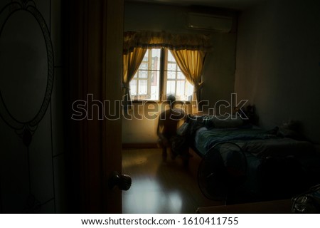 A spooky shadow squatting behind the bed, Thriller concept, Blurred edit Royalty-Free Stock Photo #1610411755