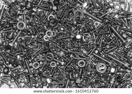 A lot of bolts nuts and washers on a white background.