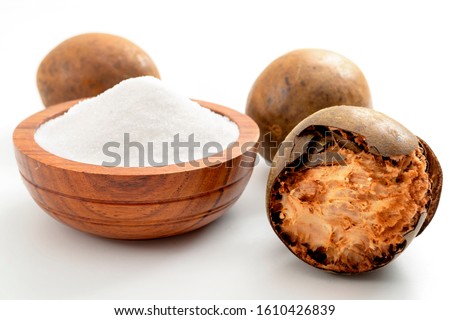 Low calorie alternative to sugar and natural remedy for inflammatory disease and arthritis conceptual idea with Luo Han Guo or Monk fruit and bowl of powder sweetener isolated on white background Royalty-Free Stock Photo #1610426839