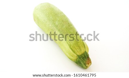                
On the photo pictured is a zucchini squash on a white background                