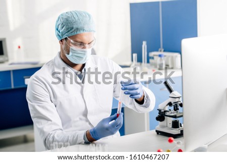 genetic consultant in white coat doing dna test in lab
