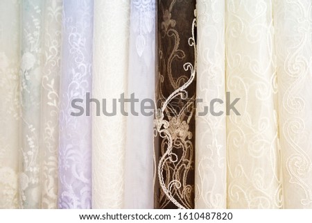 multi-colored fabric for curtains in the salon shop curtains. background of different colored fabrics