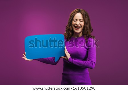 laughing woman holding speech bubble on purple background