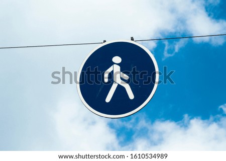 Pedestrian sign at a road crossing for security control
