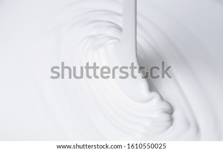 Pouring white viscous liquid, acrylic paint Royalty-Free Stock Photo #1610550025