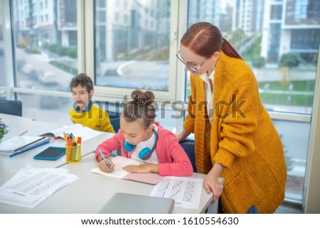 Paying attention to details. The teacher using an individual approach during the class Royalty-Free Stock Photo #1610554630