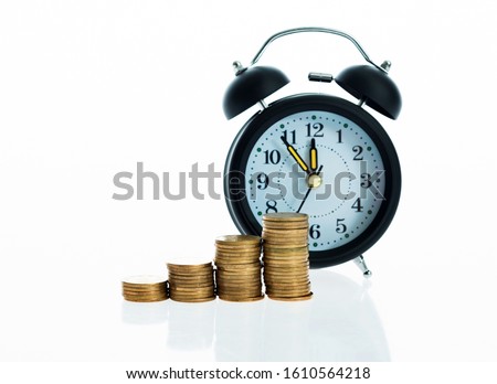 Clock and coins isolated on white background.