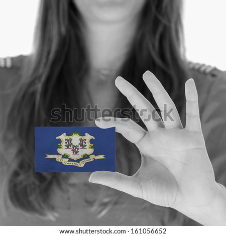 Woman showing a business card, black and white, Connecticut