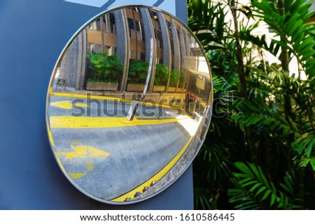 picture of a traffic mirror at the driveway of an underground parking garage